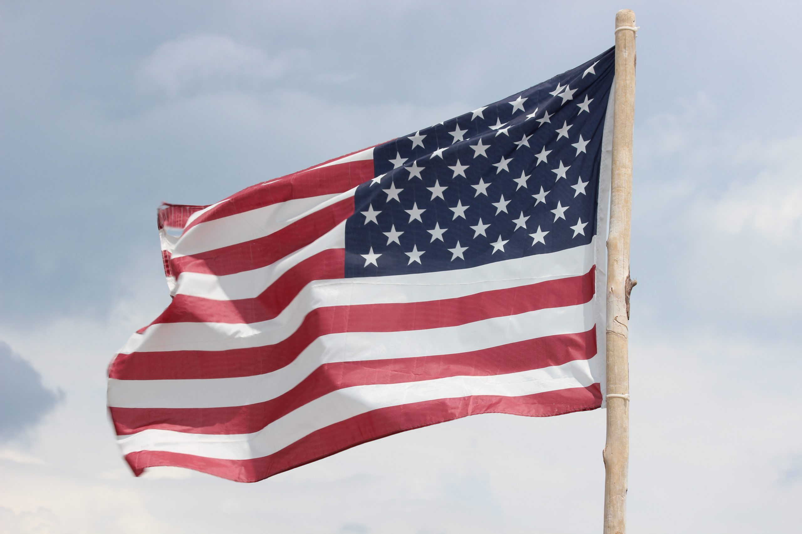 American flag with wooden stick flagpole