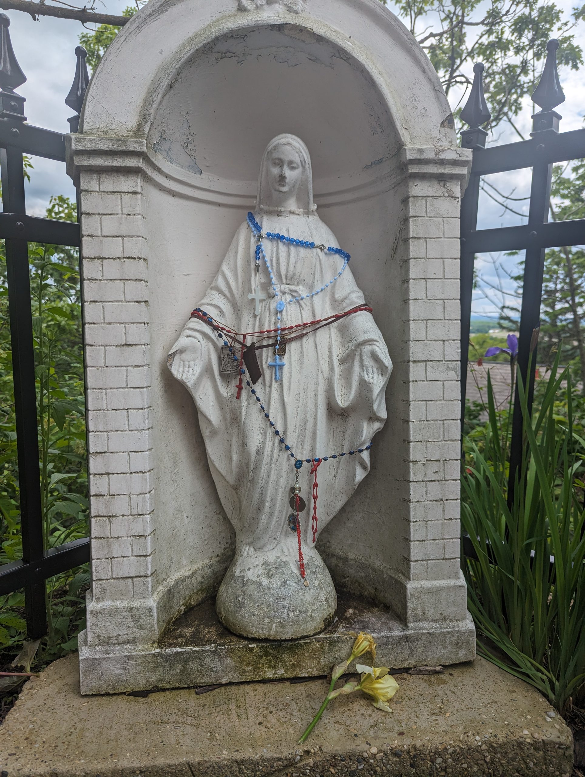 A statue of the Virgin Mary, covered in rosaries, at Holy Hill